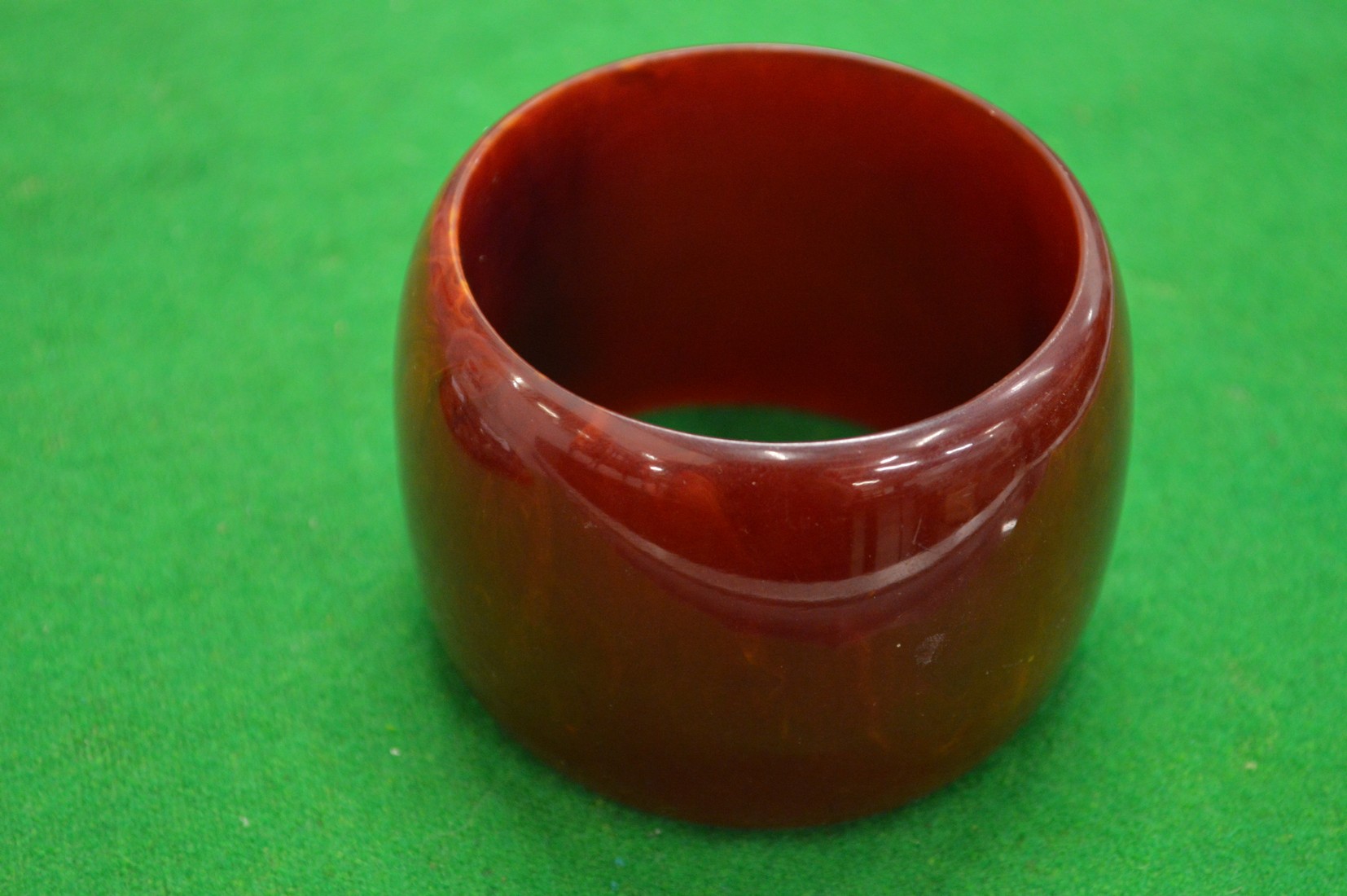 A cherry red amber style bangle.