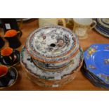 An ironstone straining dish and stand and various similar plates and bowls.