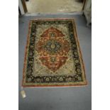 A Persian part silk rug, with stylised floral decoration 4'4" x 3'.