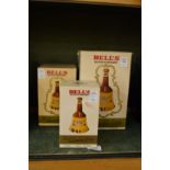 Three boxed Bells whiskey decanters, various sizes.