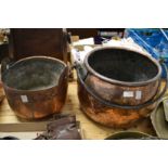 Two large copper cooking pots.