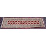 A Persian design runner, cream and red ground with a single row of ten gulls 9'0" x 2'7".