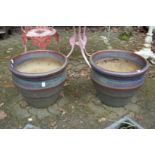 A pair of large glazed plant pots.