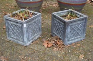 A pair of square lead style garden planters.