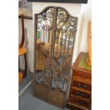 An unusual wrought iron framed gate style mirror.