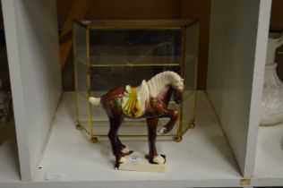 A Tang style horse and a miniature display cabinet.