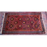 A Persian design rug, pink ground with geometric panels 6'6" x 3'10".