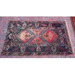 A Persian carpet, pale pink central ground stylised geometric decoration 6'7" x 4'.