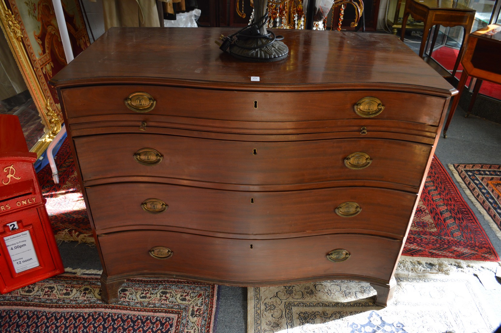 A good George III mahogany serpentine fronted chest of four graduated long drawers with brushing