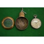 A pocket watch in a brass travelling case.