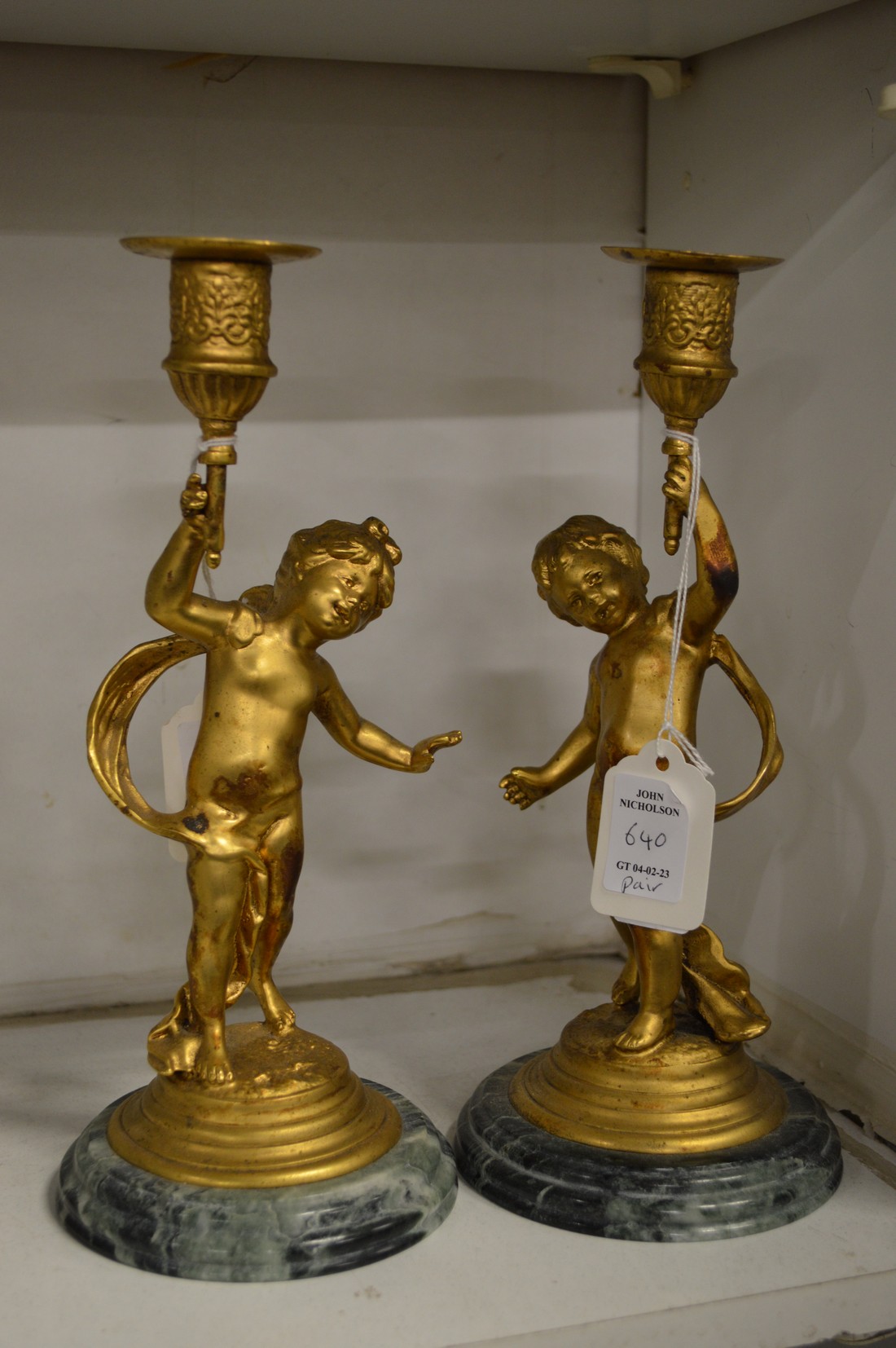 A pair of gilt metal figural candlesticks.