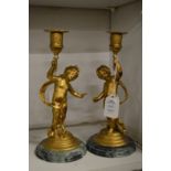 A pair of gilt metal figural candlesticks.