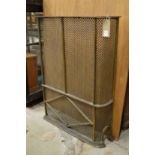 Steel and brass part radiator cover.