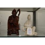 Chinese carved wood figure of a seated deity together with a blanc de chine figure of a seated