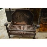 Cast iron fire grate with integral cast iron back.