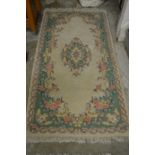 A cream ground floral decorated Indian rug 6ft x 3ft.