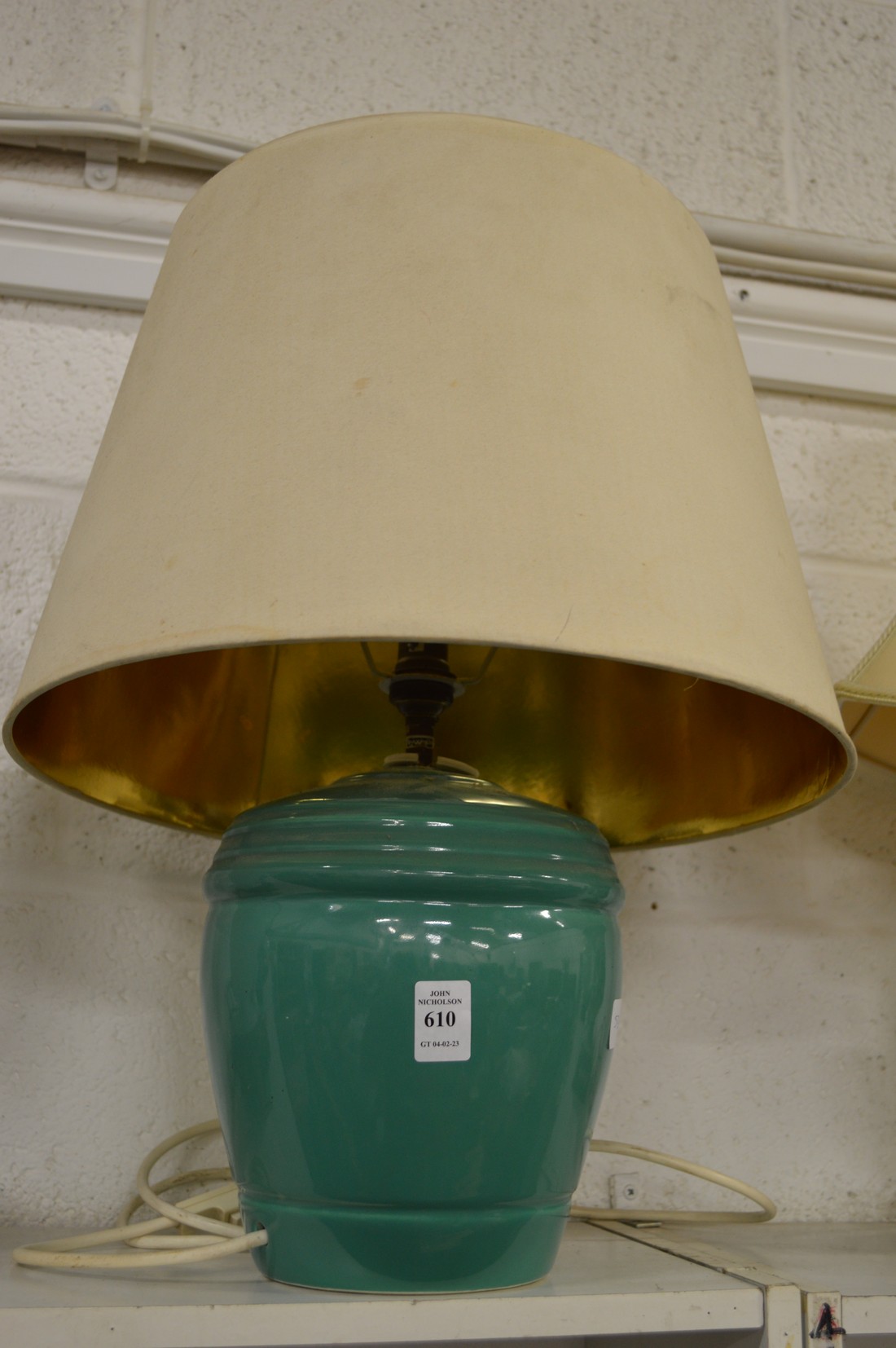 A green glazed pottery table lamp and shade.