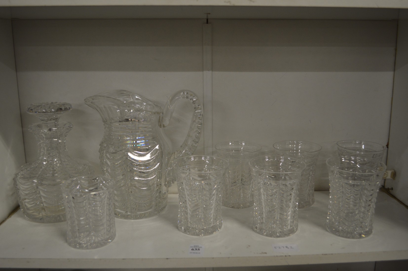 A good Stuart cut glass jug with six tumblers together with a matching decanter and smaller