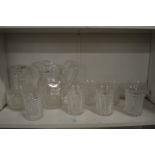 A good Stuart cut glass jug with six tumblers together with a matching decanter and smaller