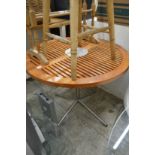 A teak and aluminium circular table.