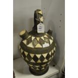 A Spanish terracotta decorative jug with side spout.