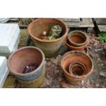 A quantity of terracotta plant pots etc.