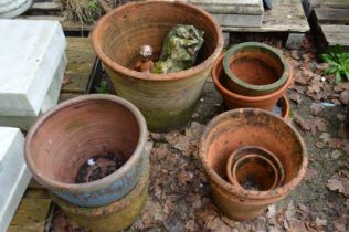 A quantity of terracotta plant pots etc.