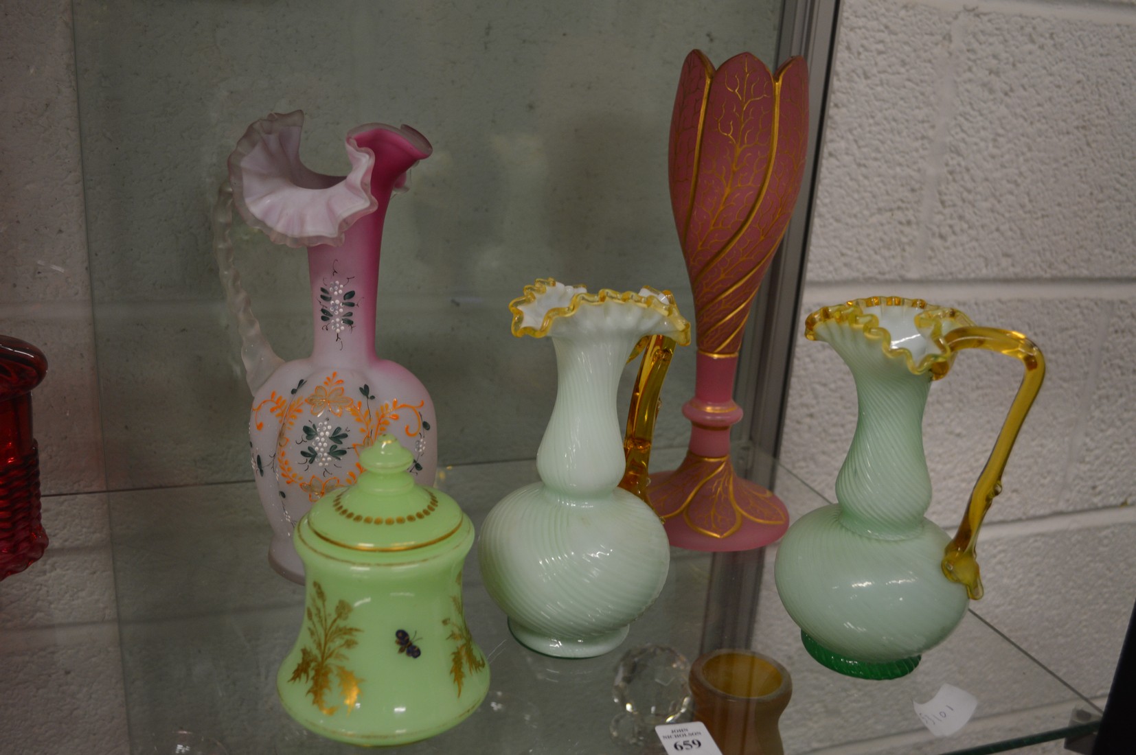 Three frilly edged opaque glass jugs and two other items.