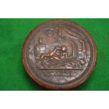 An embossed wood and tortoiseshell circular snuff box and cover.