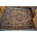 A Persian carpet with stylised floral decoration 6'8" x 5' (some damage).