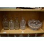 Four cut glass whisky decanters and a cut glass pedestal bowl.