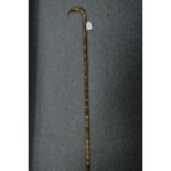 A segmented horn walking stick with silver collar.