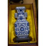 A contemporary Chinese blue and white porcelain vase and stand with fitted box.