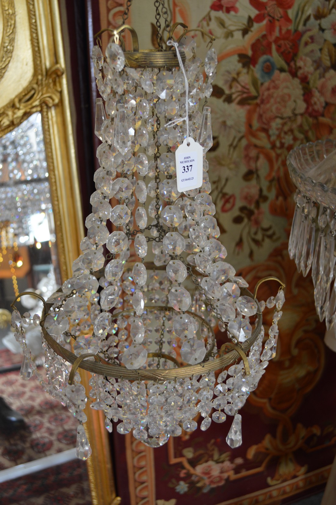 A cut glass and brass three tier chandelier.