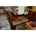 A mahogany twin pedestal extending dining table and six various chairs.