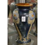 A Royal Doulton baluster shaped vase with moulded floral decoration.