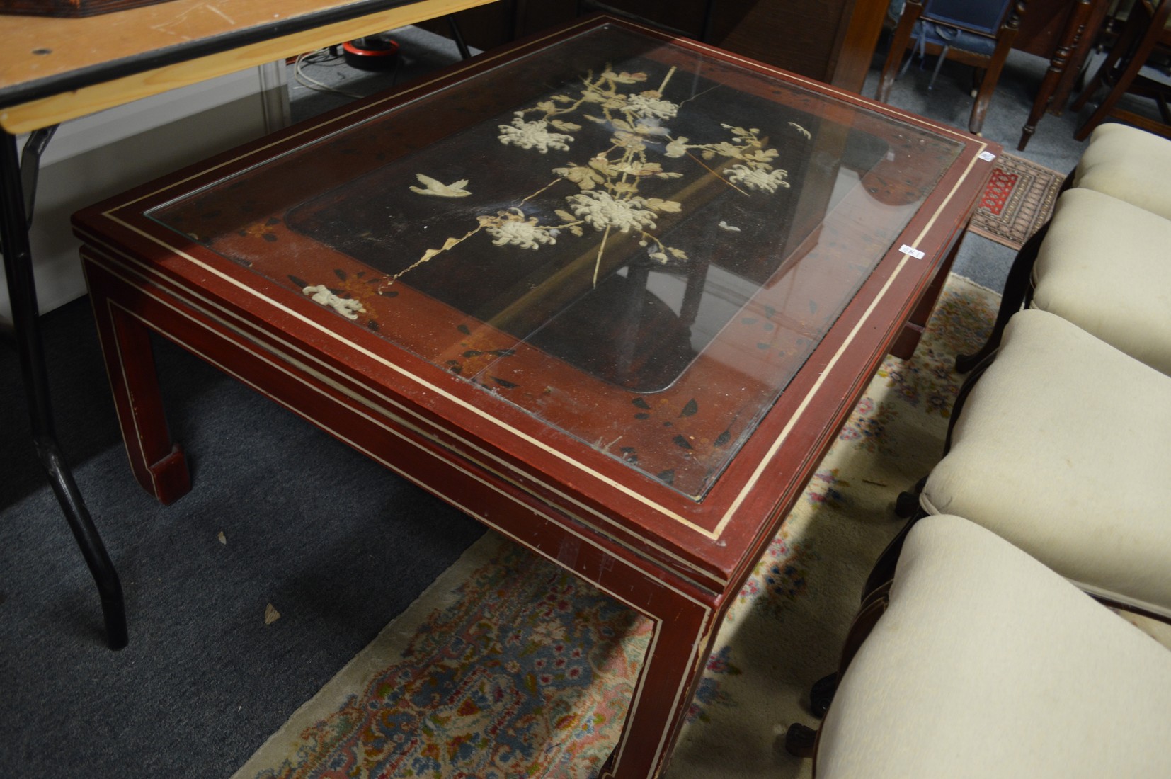 A Chinese lacquer large coffee table with onlaid and inlaid panelled top (af).