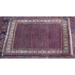 A Persian rug, dark blue ground central panel with Boteh decoration 4'10" x 3'1".