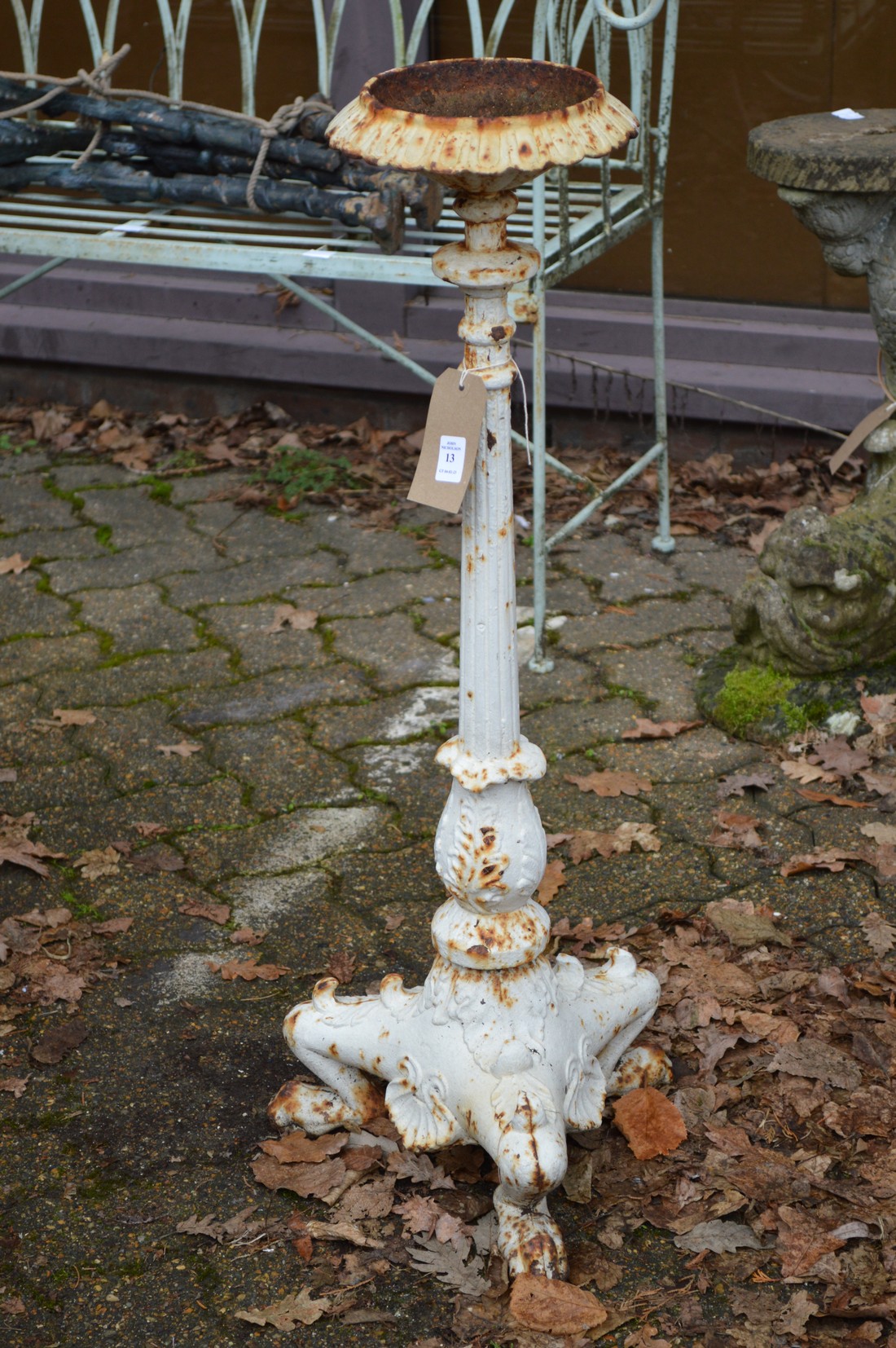 A cast iron pedestal candle stand or jardiniere.