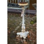 A cast iron pedestal candle stand or jardiniere.