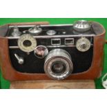 An Argus Cintar 50mm camera with a leather case together with another camera.