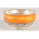 A TIBETAN SILVER MOUNTED AMBER BOWL, 11cm diameter.