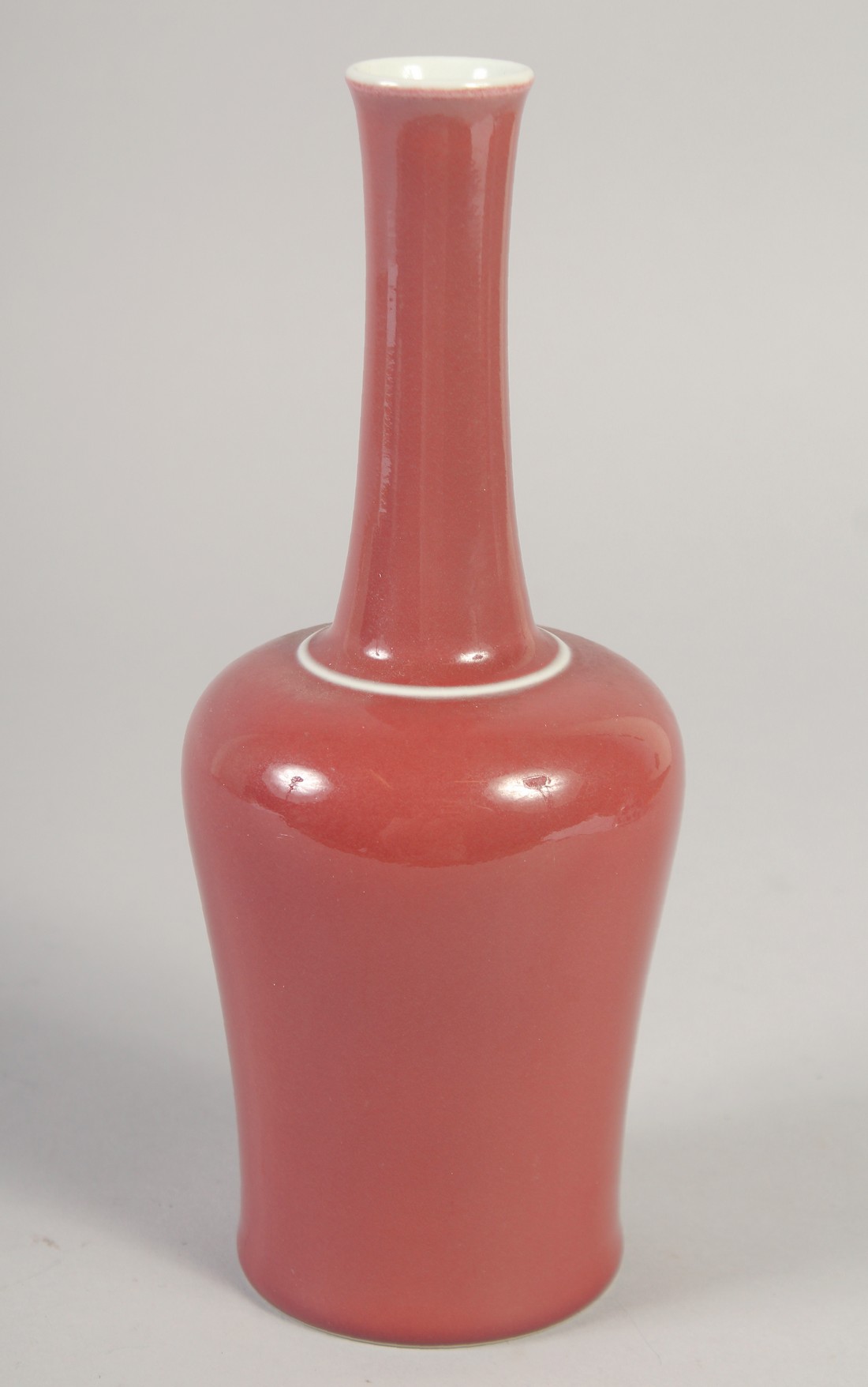 A CHINESE REPUBLIC COPPER RED GLAZE BOTTLE VASE, the base with character mark, 23cm high.