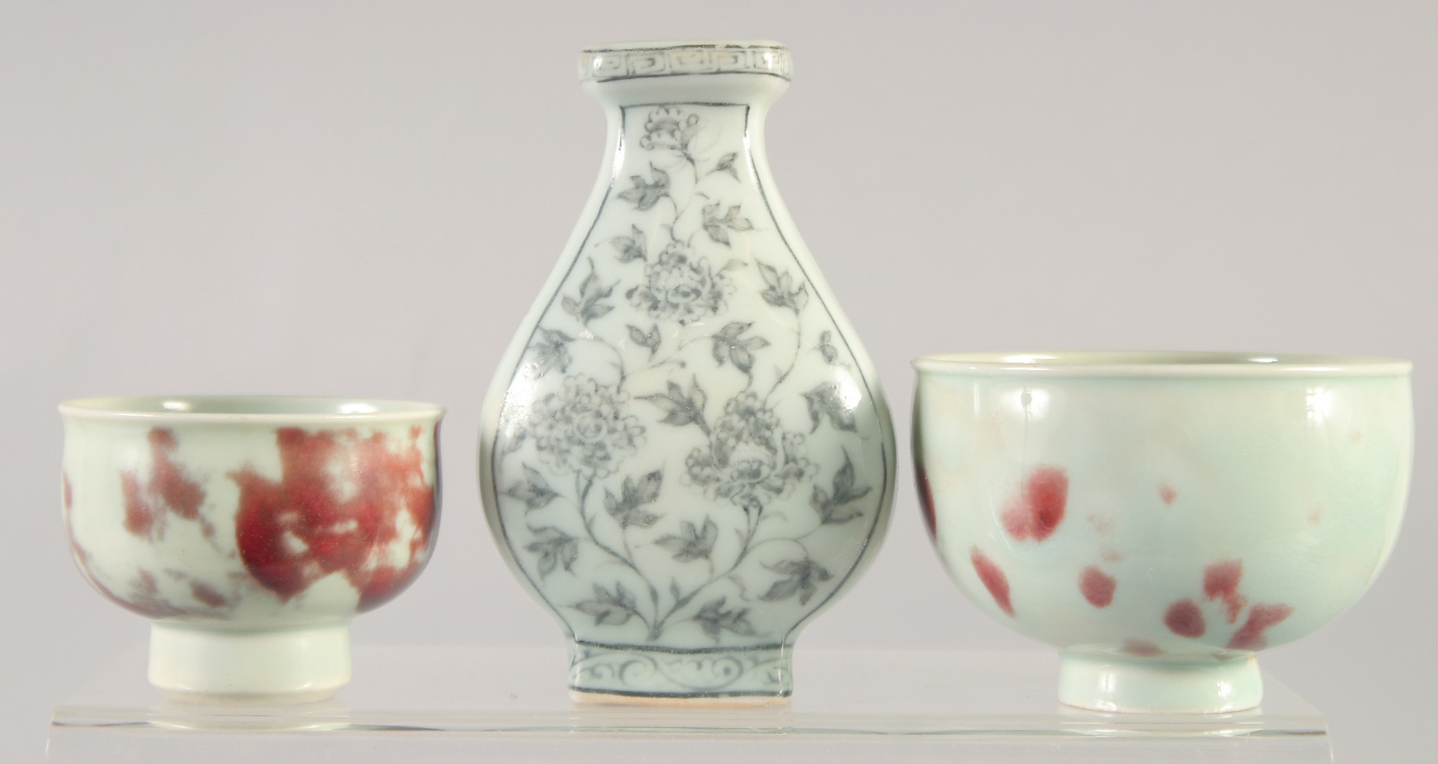 A GROUP OF THREE YUAN STYLE PORCELAIN ITEMS, comprising two cups and a vase, (3).