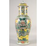 A LARGE CHINESE YELLOW GROUND FAMILLE VERTE PORCELAIN VASE AND COVER, painted with a dignitary