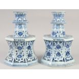 A PAIR OF A CHINESE BLUE AND WHITE PORCELAIN OCTAGONAL CANDLESTICKS, 27.5cm high.