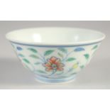 A CHINESE DOUCAI PORCELAIN CUP, with floral decoration, six-character mark to base, 9cm diameter.