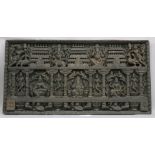 A MONUMENTAL DEEPLY CARVED WOODEN PANEL, depicting various Hindu gods seated on a lotus wearing