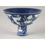 A CHINESE IMPERIAL BLUE GLAZE PORCELAIN STEM BOWL, decorated with white fish and flora, six-