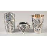 THREE ORIENTAL SILVER ITEMS; a dragon goblet, a octagonal container and a miniature tripod bowl,